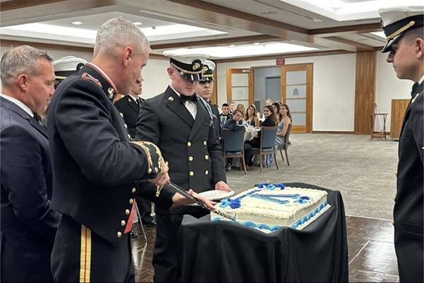 Villanova battalion and staff cut the cake to celebrate the Navy and Marine's birthdays.