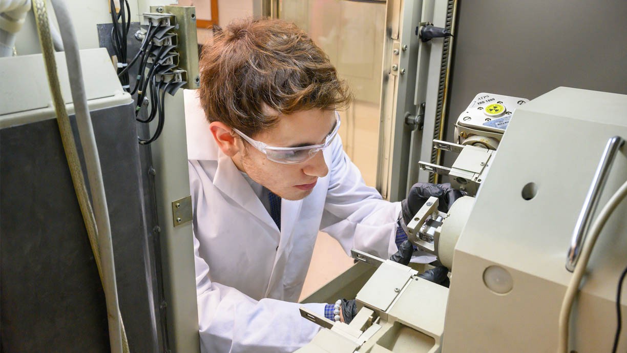 Physics student working with lab equipment.