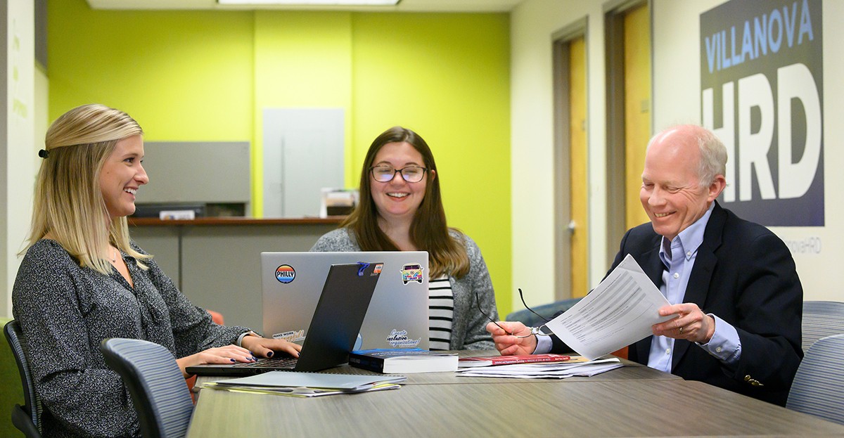 Villanova HRD students and faculty sitting at a table