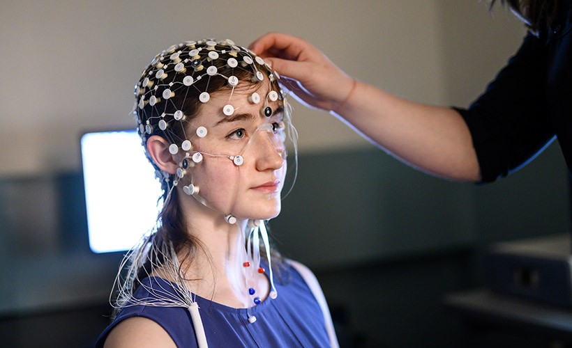 A student participates in a research experiment in a Psychology lab.