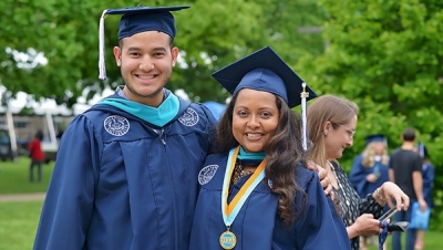 Two Villanova MPA students in graduation caps and gowns