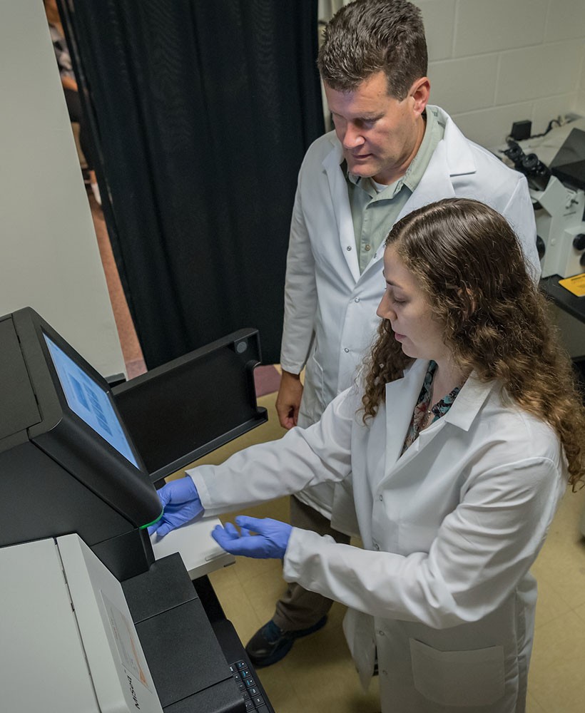 A professor and student work together in the lab.