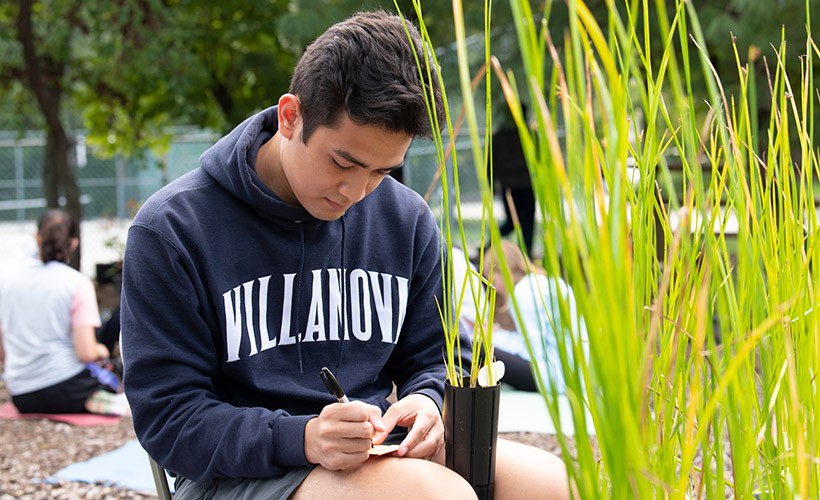 Student does research in the sustainability garden.