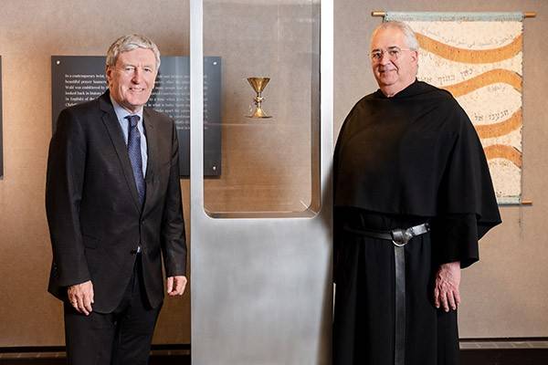 Daniel Mulhall, left, and University President the Rev. Peter M. Donohue, right, stand on either side of the chalice.