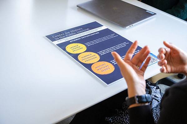 A student looks at a flyer listing several student opportunities