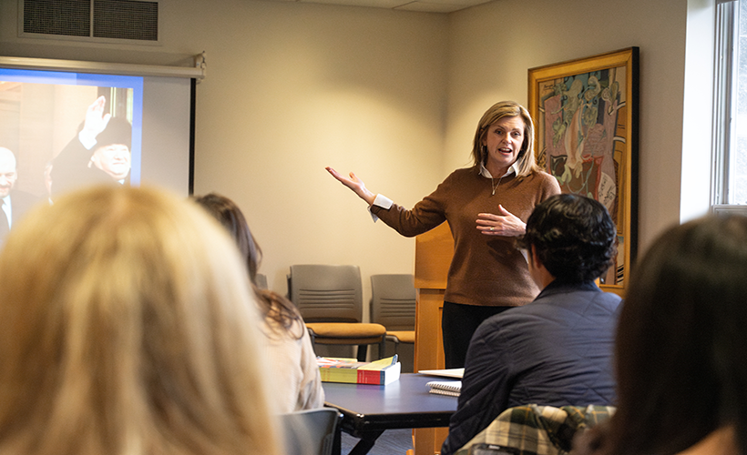 A woman teaching a History class. A woman teaching a History class.