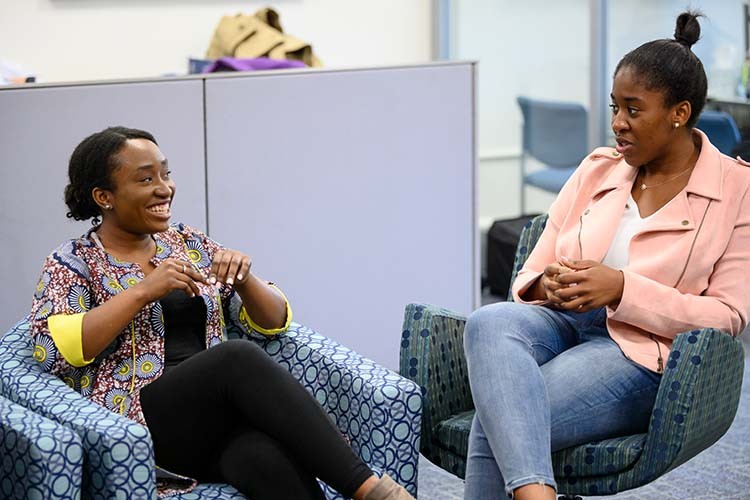 Two Female Students Talking 