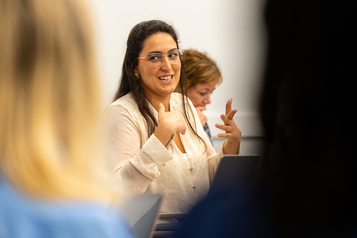 Impact Your Community Student talking to another student