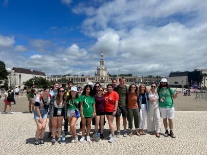 The group poses or a photo in Old Town Lisbon during World Youth Day 2023