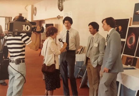 Dr. Maloney (left), Dr. Guinan (center) and researcher Craig Harris discuss their findings with a reporter during an unexpected TV interview at the 1982 American Astronomical Society Meeting.  