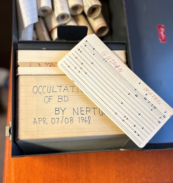 Dr. Ed Guinan's original computer cards of data from his 1968 visit to New Zealand sit in a box on his desk