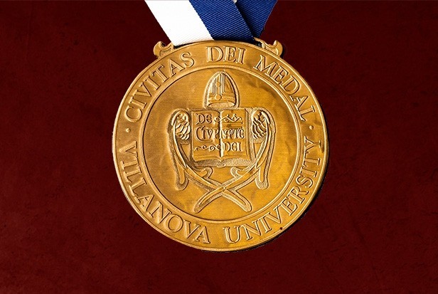 The Civitas Dei Medal on a maroon background