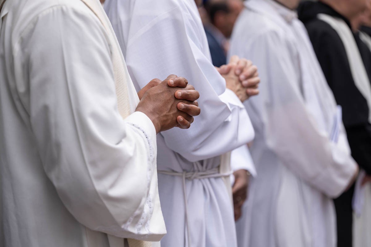 Members of the church with their hands in prayer