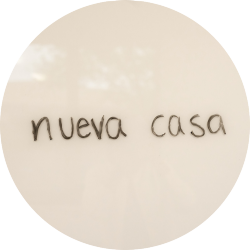The words "nueva casa" written on a whiteboard