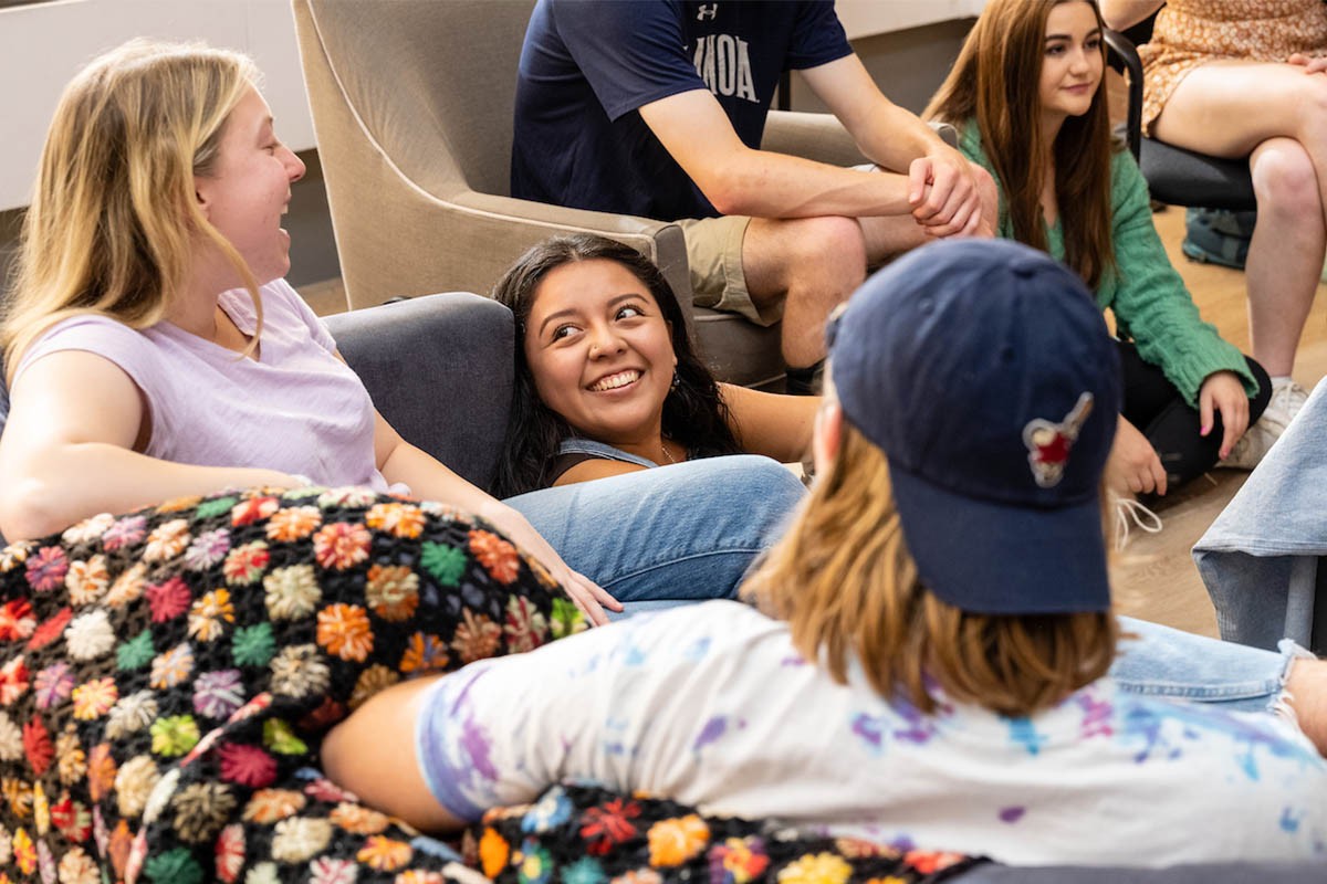 Students listening on a couch