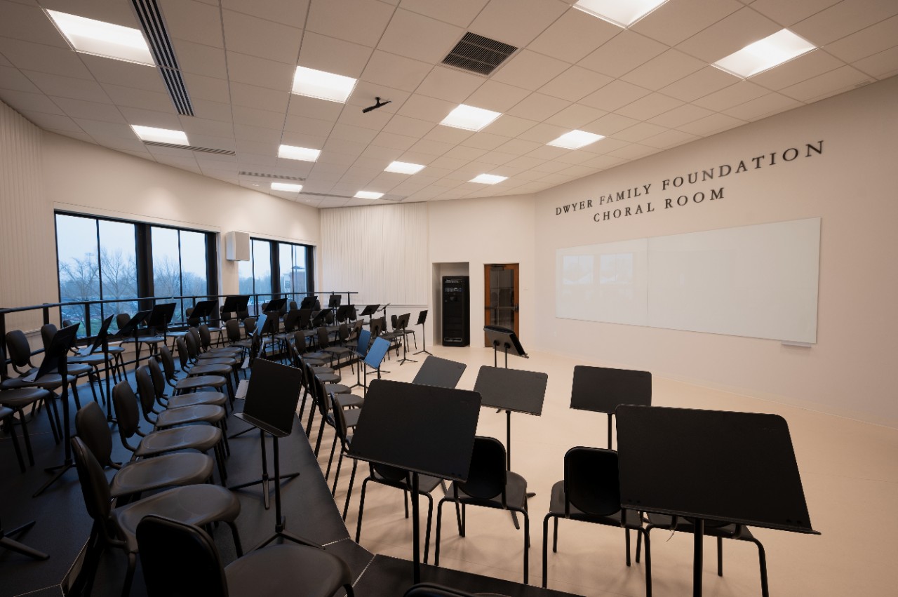 Dwyer family Foundation Choral Room filled with three risers, chairs and music stands