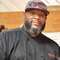 African-american male with black chef jacket and baseball hat
