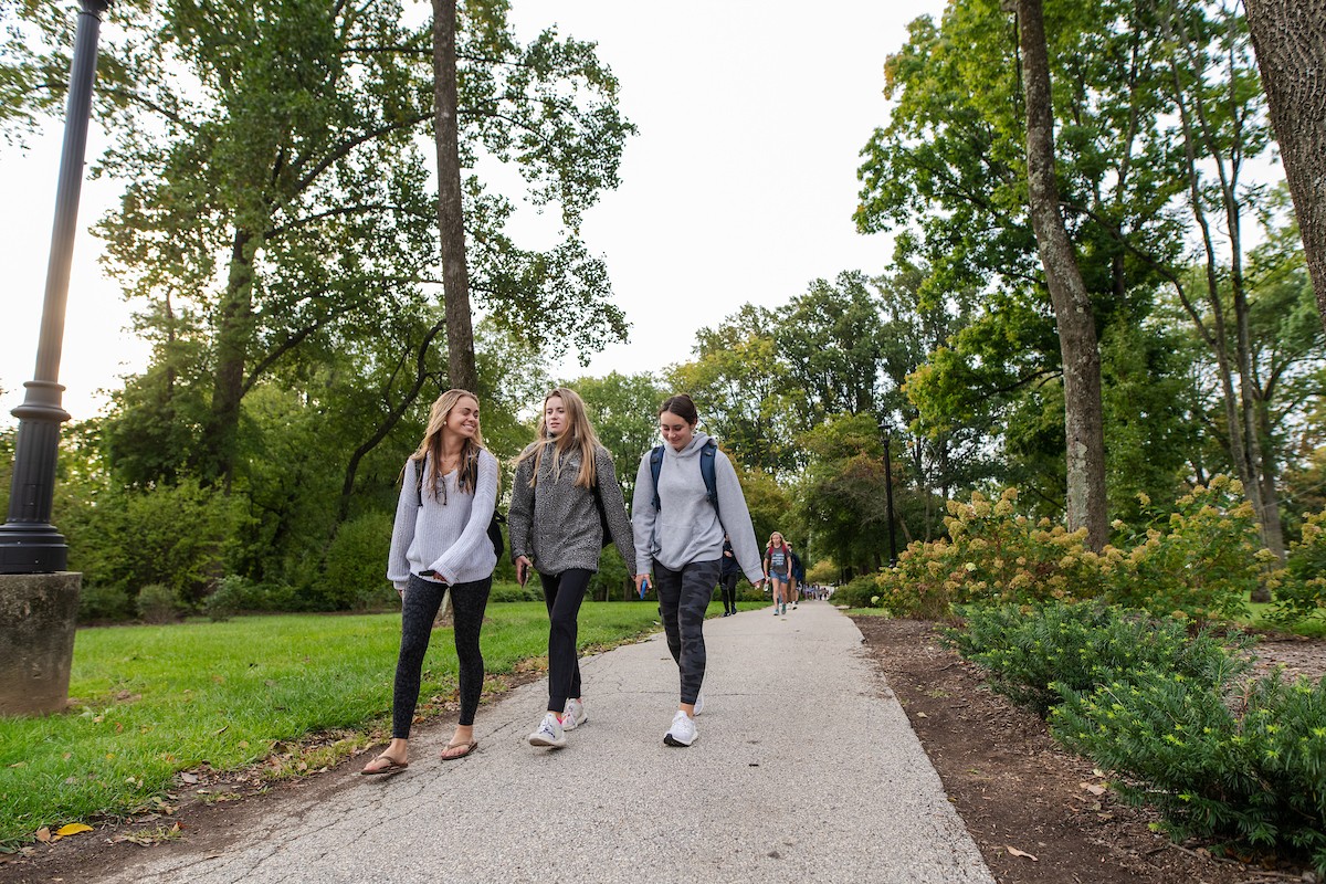 Three Students Walk Along Wildcat Path