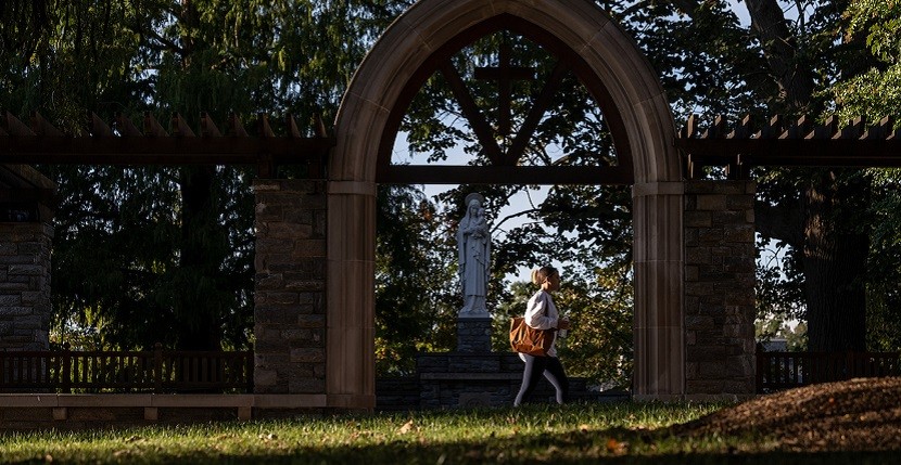 Student Walks By Grotto