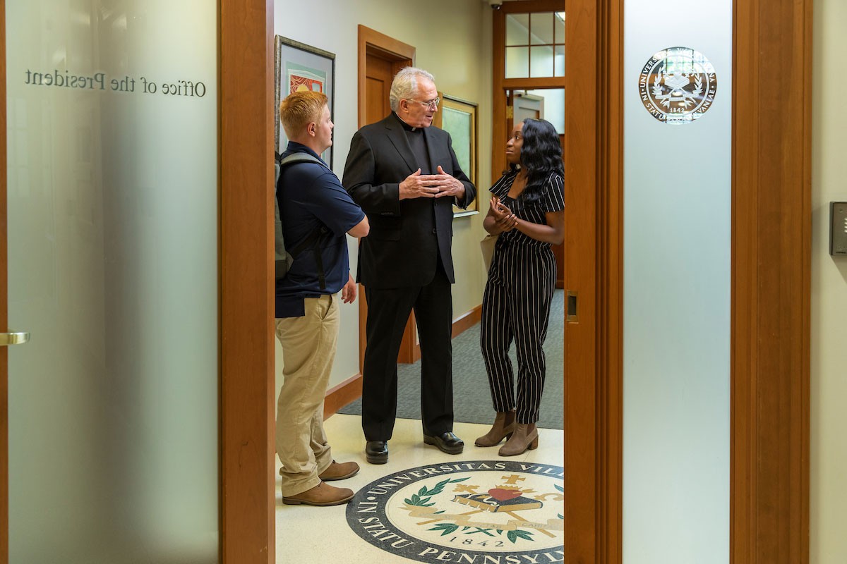 Father Peter Donohue, Villanova President, meets with students in his office.