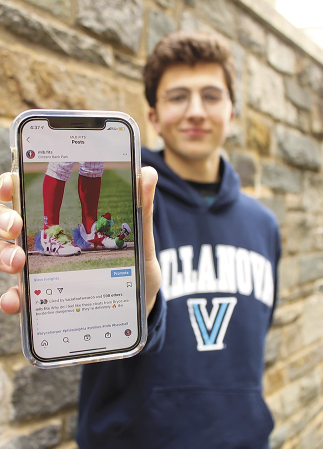 Villanova student Alex Tantum holding a cell phone displaying an image from his Instagram account