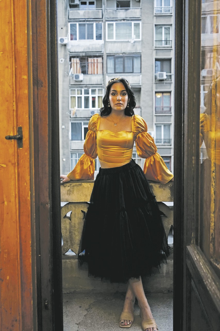 portrait of Ioana-Taisia Turescu posing on a balcony in Romania