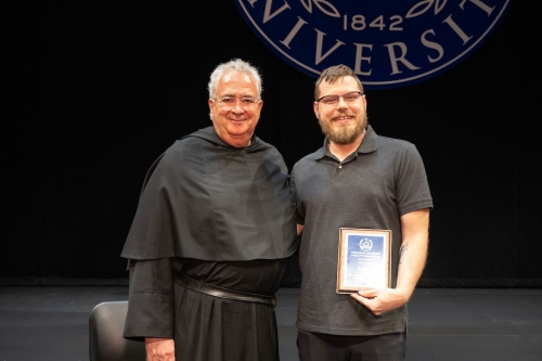 Bryan Clark poses with Father Peter