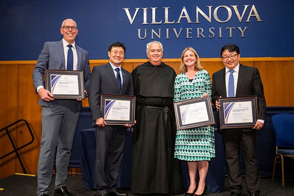 2024 Faculty Scholars Award honorees with University President the Rev. Peter M. Donohue, OSA