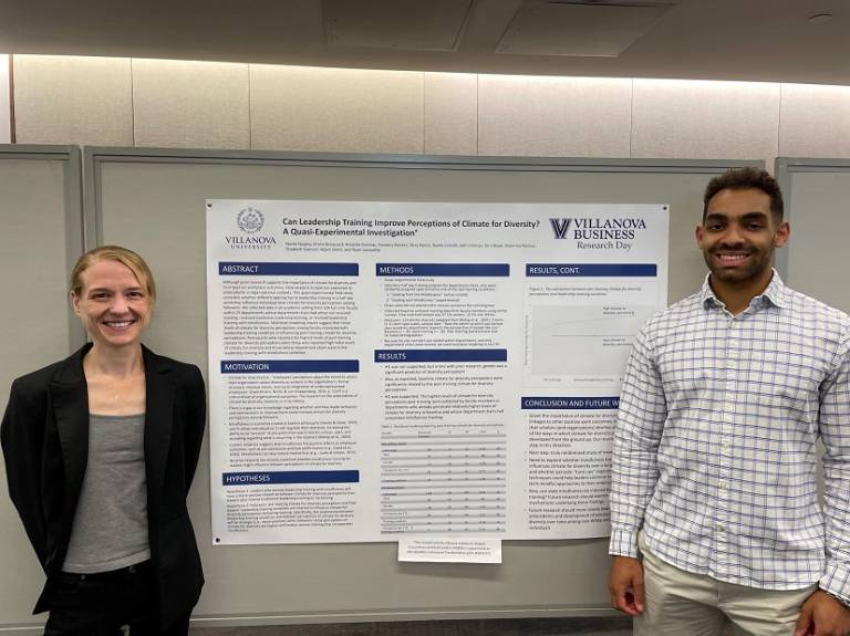 Two members of a research team stand with a poster at VSB Research Day 2023.