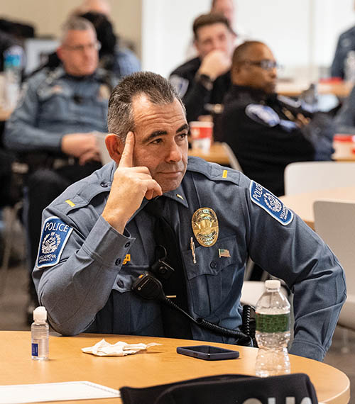 Image of a police officer listening in on a presentation