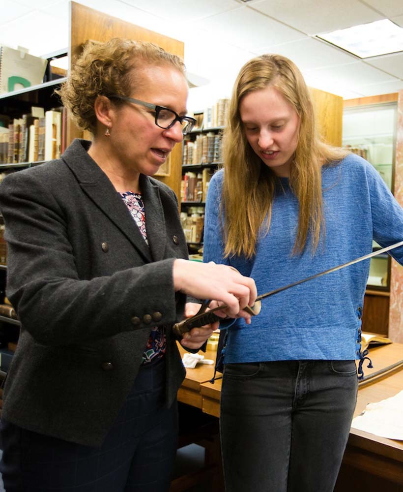 Professor showing artifact to student