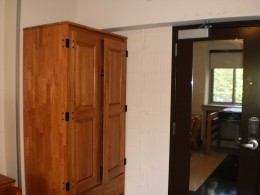 View of a wardrobe and full-length mirror on the back of the door of a Sullivan Hall double room.