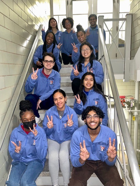 Students in the MLK Day of Service Committee pose on a stairwell in Dougherty Hall. 