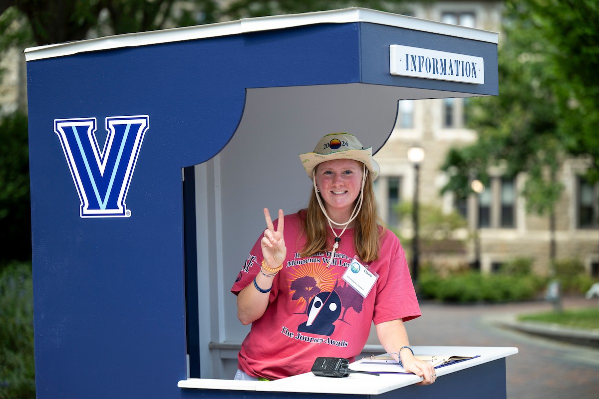 A Villanova Orientation Counselor at an information booth