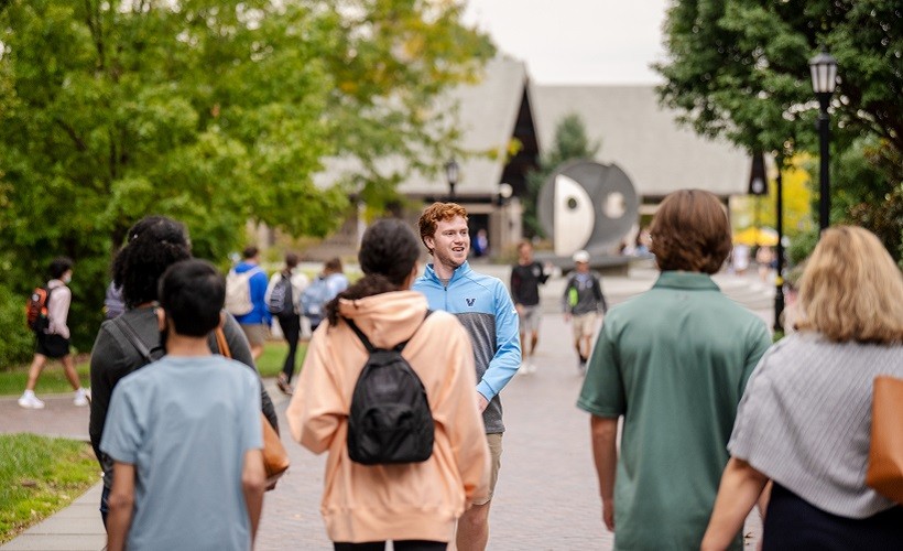 A male student leads a tour of the Villanova campus
