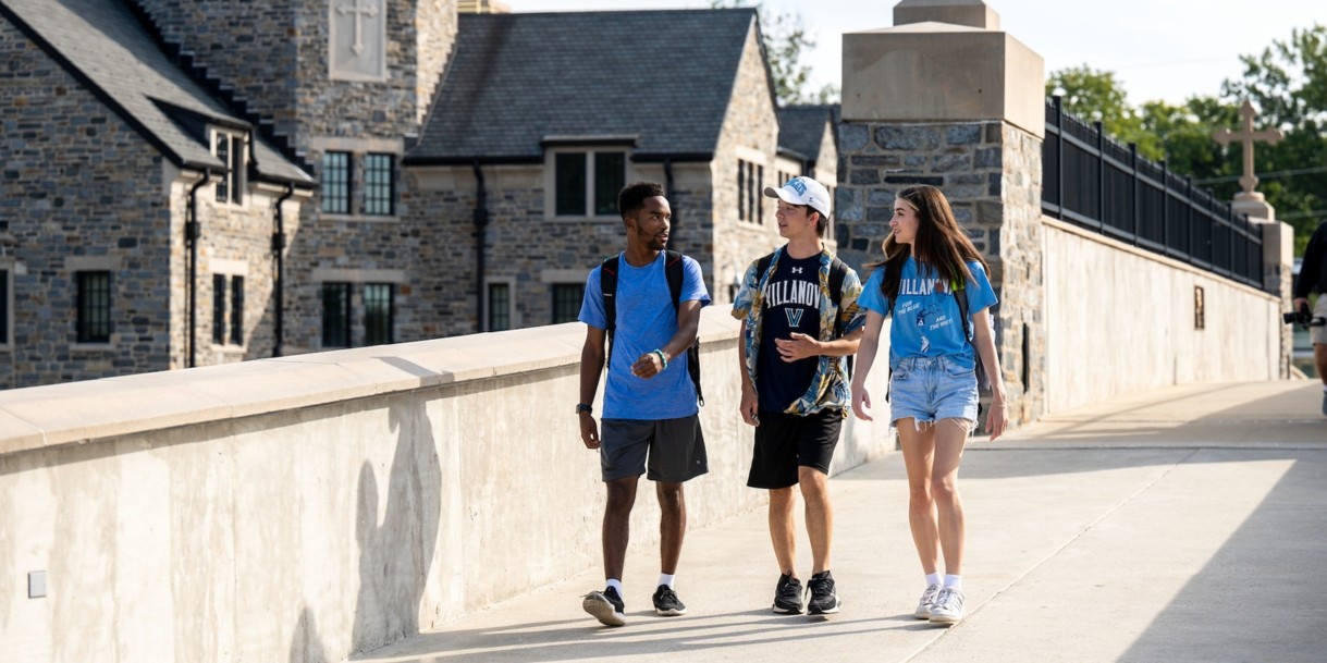 Students walking across the bridge from South Campus.