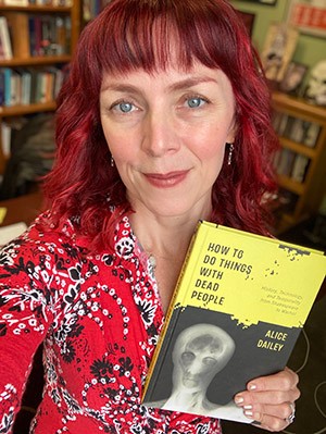 Alice Dailey holds her book, "How to Do Things with Dead People: History, Technology, and Temporality from Shakespeare to Warhol."