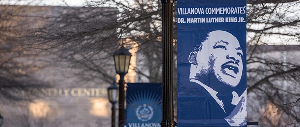 campus banner hanging from lamp post and depicting MLK