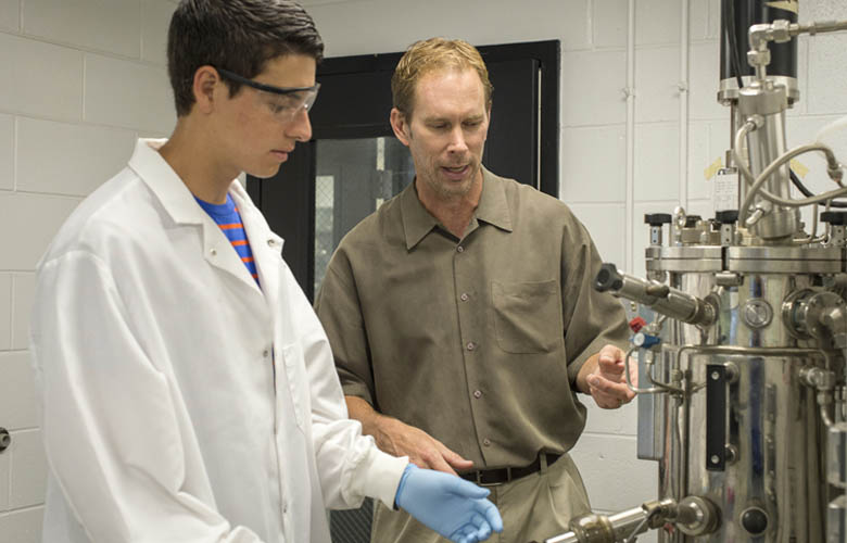 Associate Professor William Kelly, PhD, Chemical Engineering, works with an undergraduate in his Bioprocessing Laboratory.