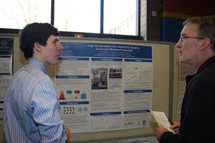 Paul Campo ’15 ChE (left) presents his award-winning research at the Sigma Xi Student Research Poster Symposium.