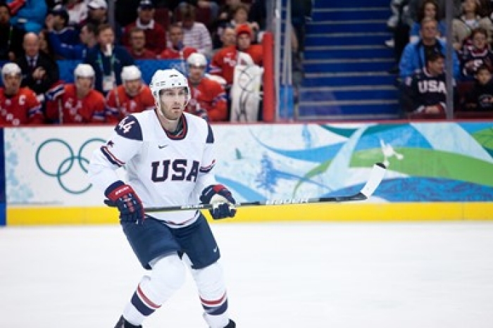 USA hockey player on the ice playing in the USA v Norway men's hockey game during the Vancouver Olympics