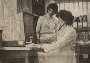 Maura Buri with new microfilm machine, 1980