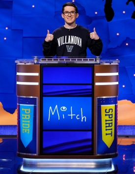 mitchell macek on jeopardy set giving two thumbs up