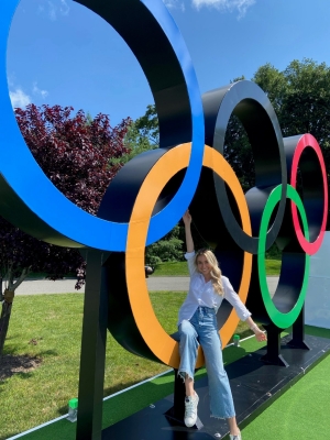 Emma Gudino posing at Olympic rings at NBC Sports headquarters in Stamford, Connecticut