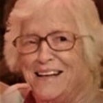 Elderly woman smiling, gray hair, glasses
