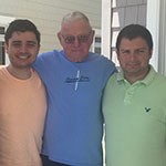 grandfather-with-arms-around-young-adult-grandsons