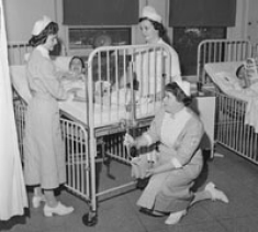 Class of 1957 students Dolores Cofield and Winifred Daly enjoy a clinical experience at Children's Hospital of Philadelphia with fellow Villanovan Helenterese Coffey. August 8, 1956.