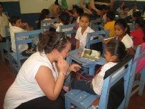 Maureen Kringas and other Villanova Nursing students teach Nicaraguan schoolchildren how to listen to their heart and lung sounds.