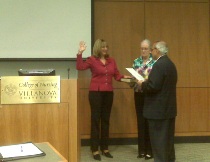 The swearing in of newest member of the Board