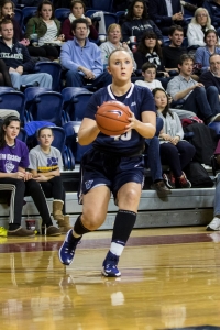 Grace Stant takes a shot during a womens basketball game